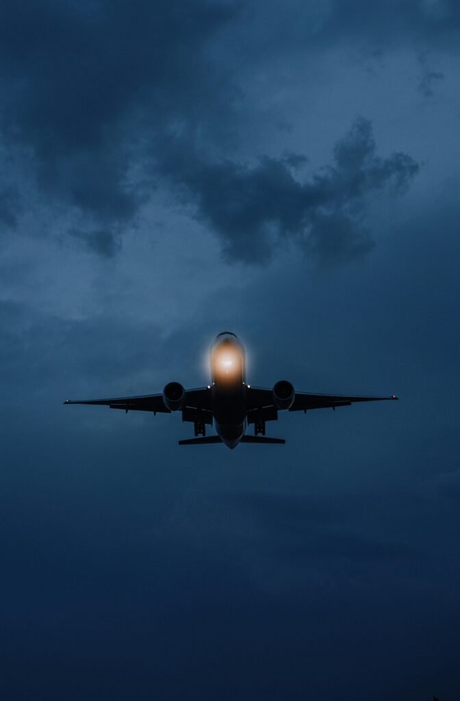 A dramatic shot of an airplane against a moody night sky in Istanbul.