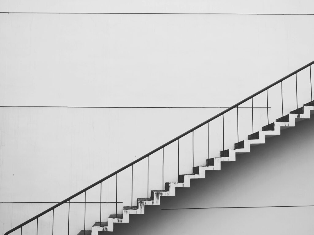 Minimalistic black and white staircase with sharp angles and clean lines, showcasing modern architecture.